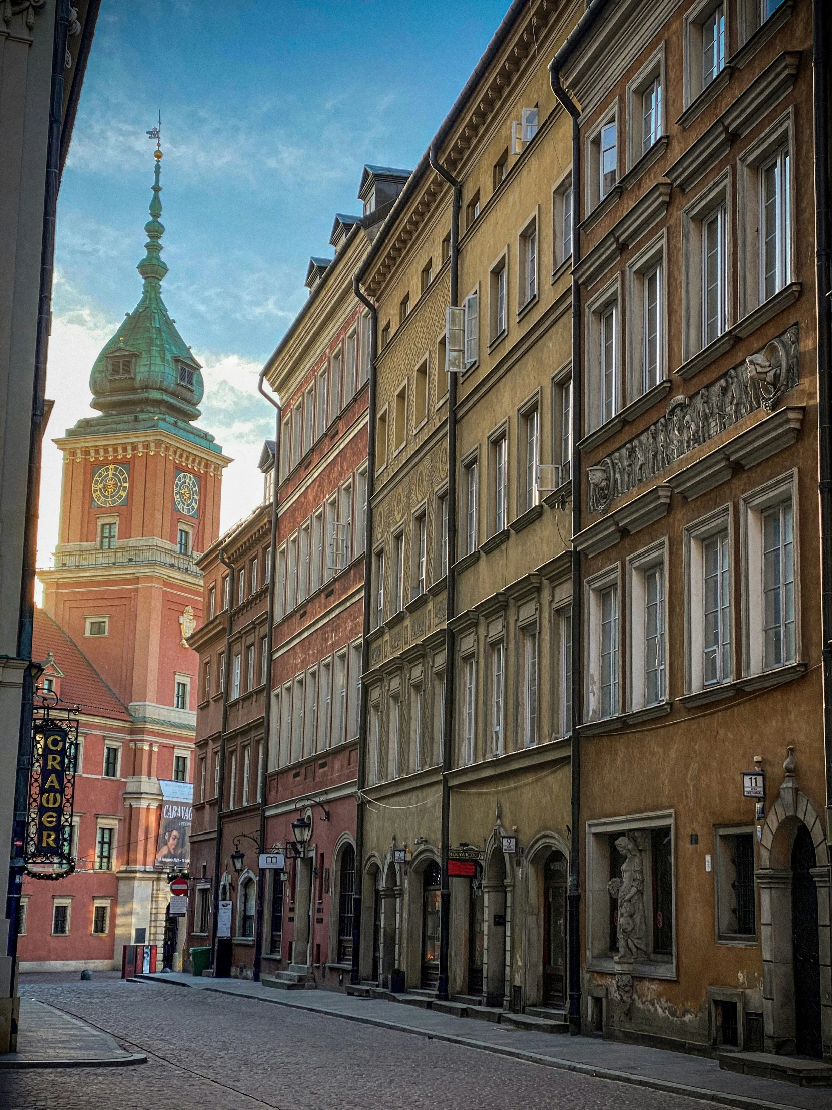 there is a clock tower towering above the buildings