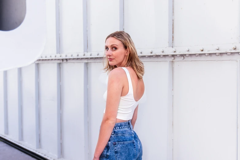 a beautiful woman in high rise jeans looking at the camera