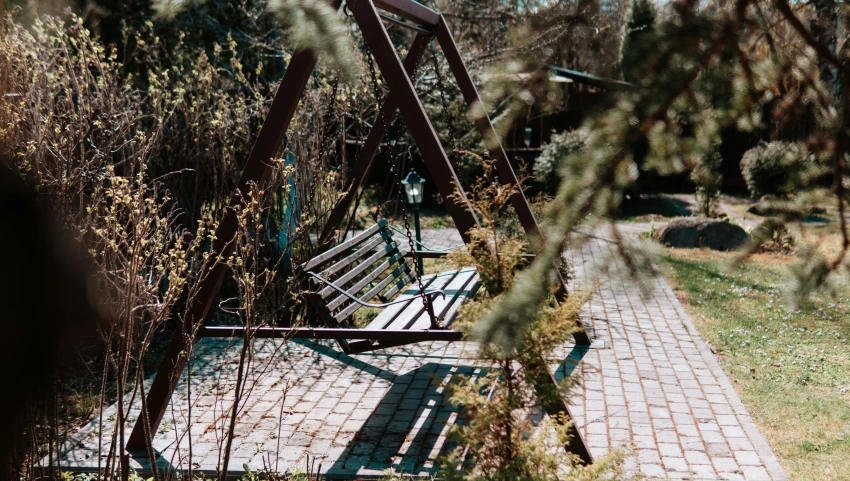 an empty swing chair by itself on the grass