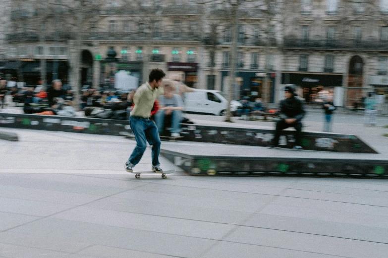 a young man riding a skateboard down a sidewalk