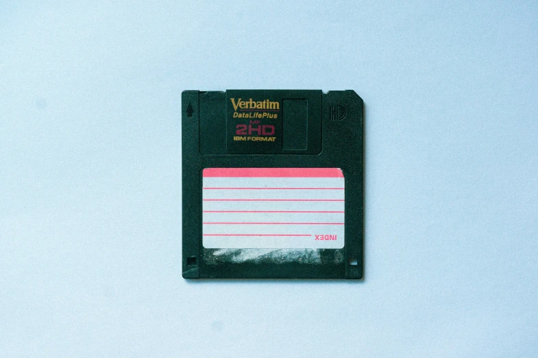 an old floppy disk with a writing block on it