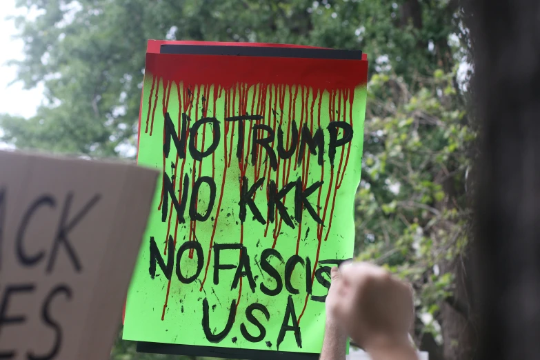 a sign with paint and black lives usa written on it