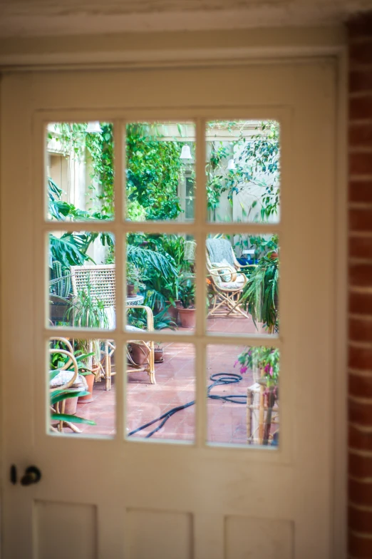 the reflection in a window looking into a brick house