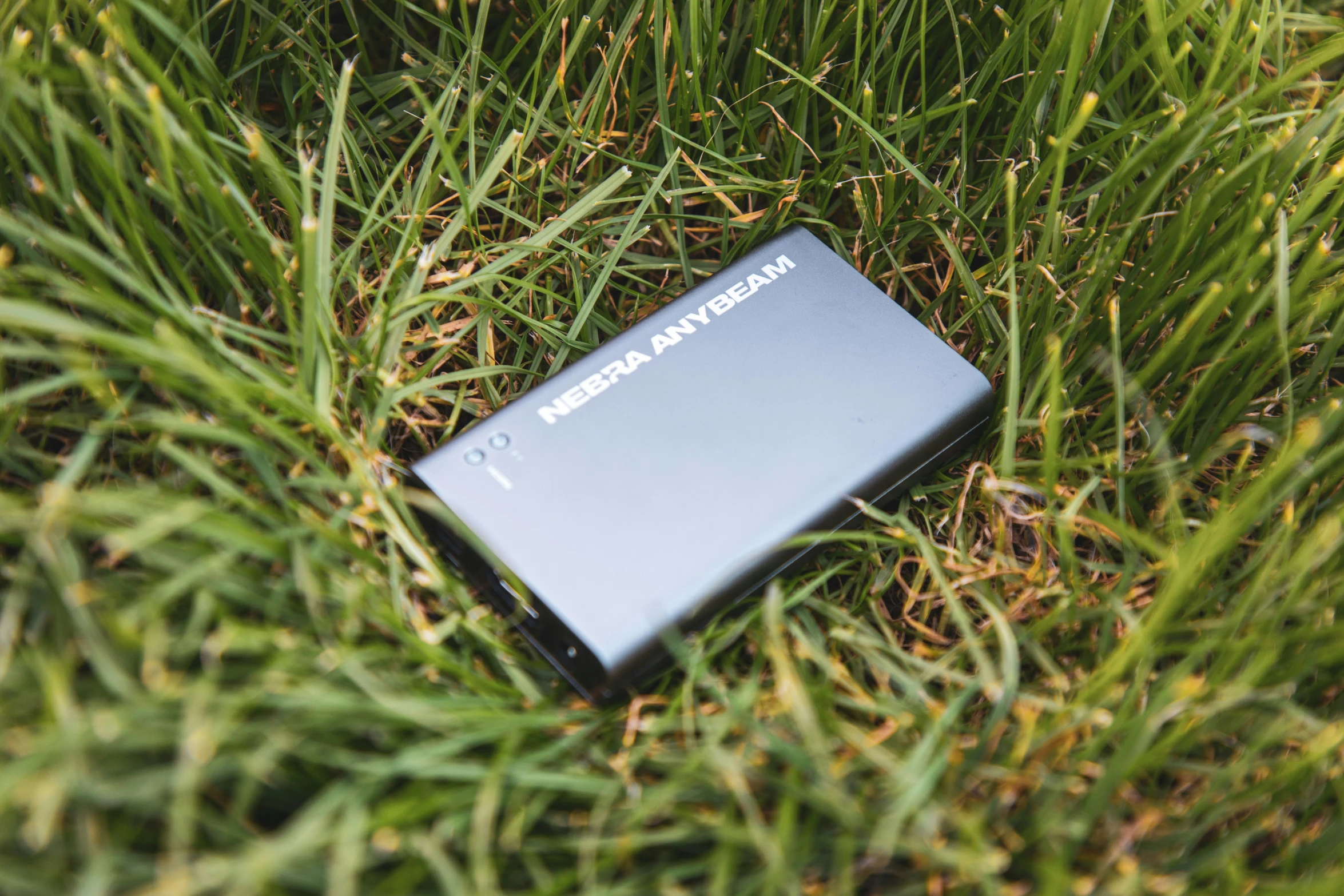 a device lying in the grass with it's face covered