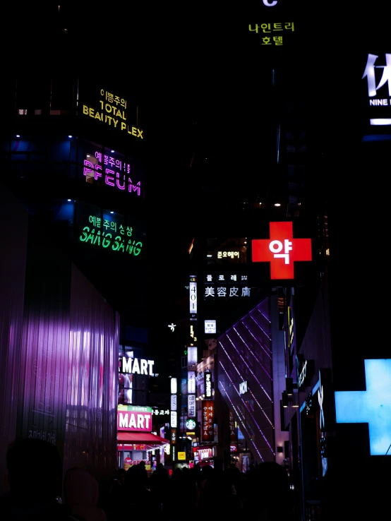 city street at night with various lighted signs