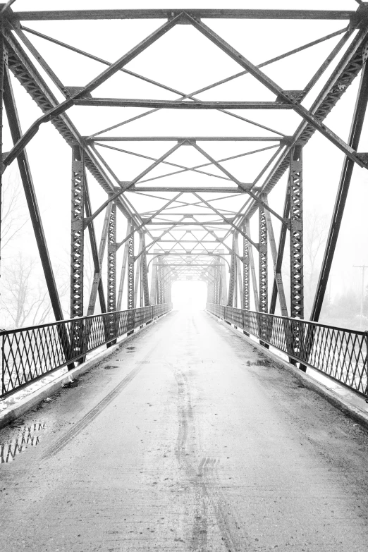 black and white pograph of a bridge in the snow