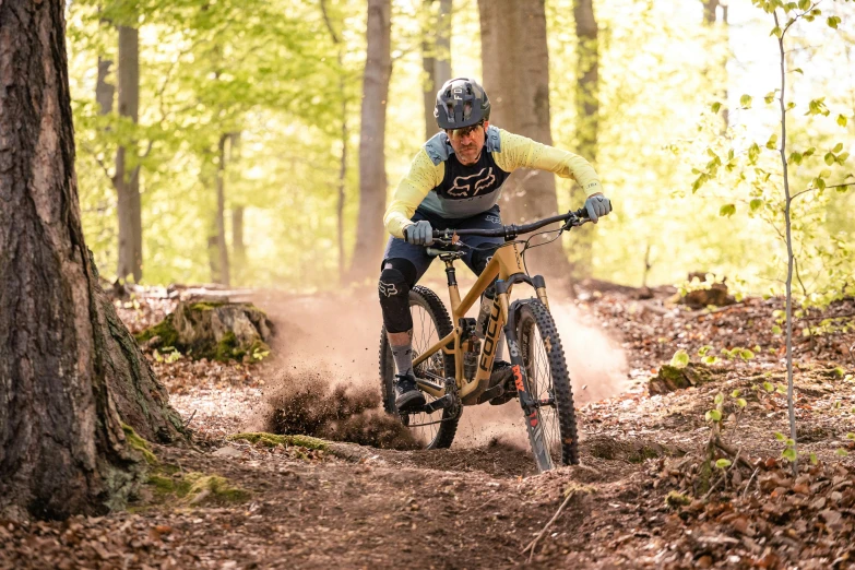 the cyclist is riding through the muddy woods