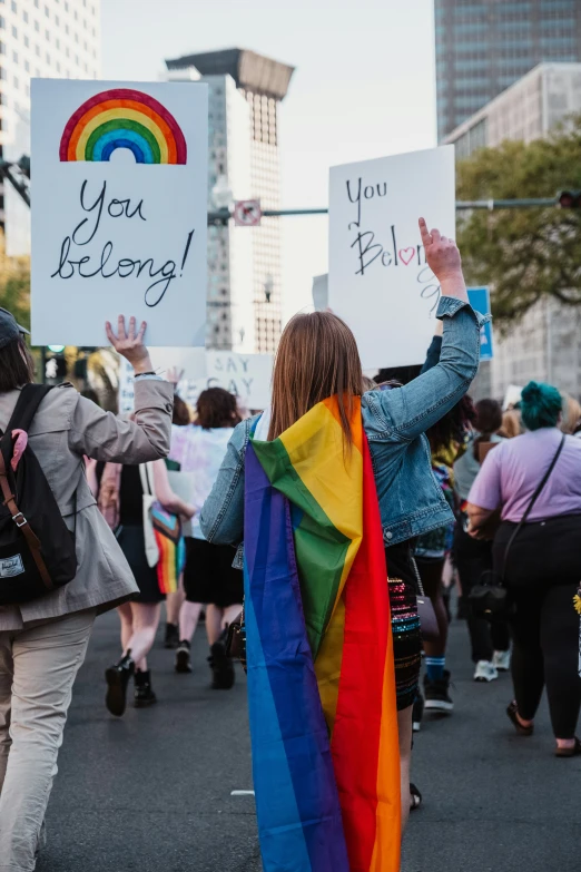 people holding signs are walking in a parade