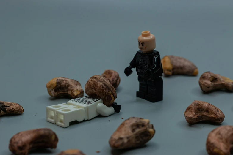 lego man with nuts and food on a table