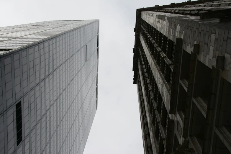 two tall buildings with windows on the side