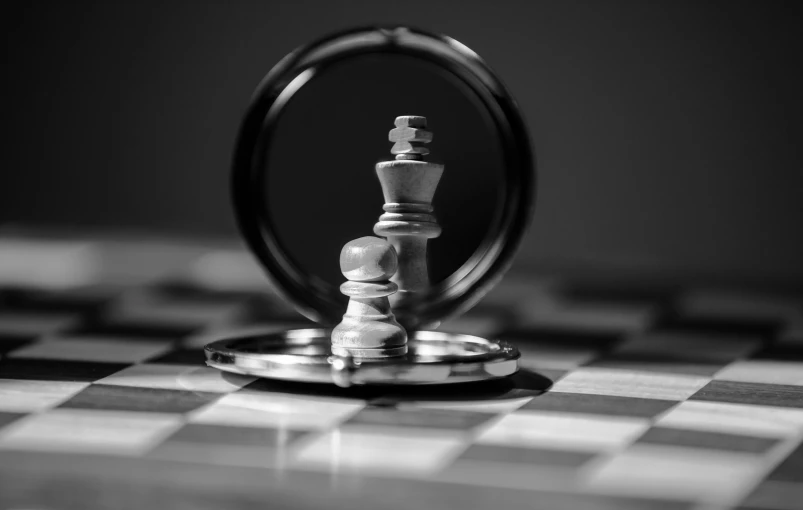 a chess piece sitting on top of a black and white chess board