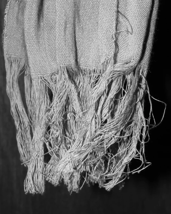 a white towel hanging up on a black wall