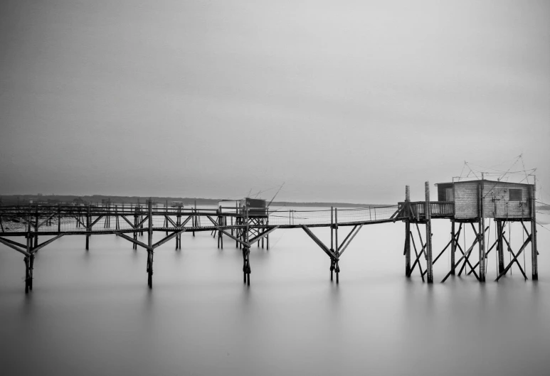 an ocean dock in black and white with a structure