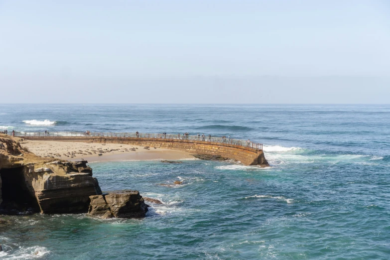 several people standing on the edge of a pier over water