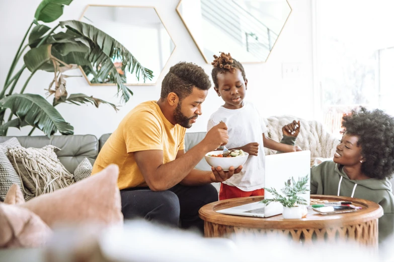 a family gathered in a living room eating a meal