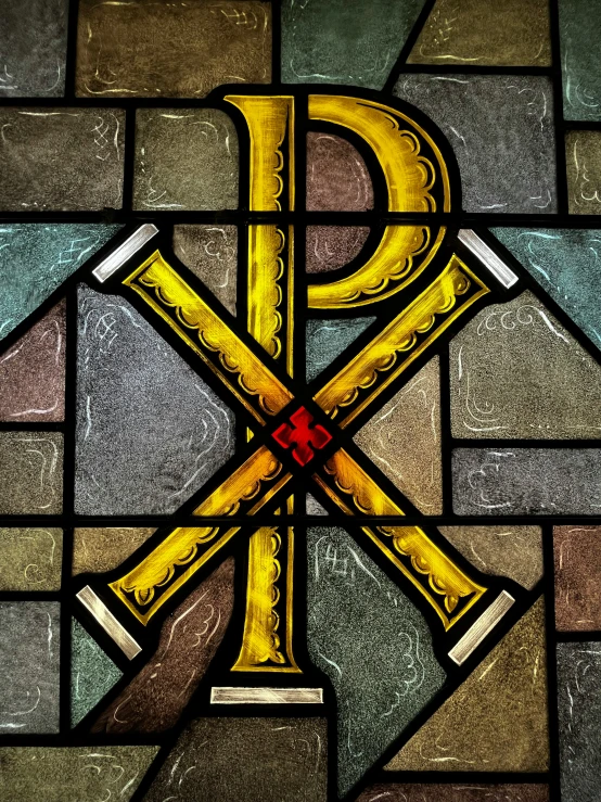 the large letter p is displayed on a stained glass window