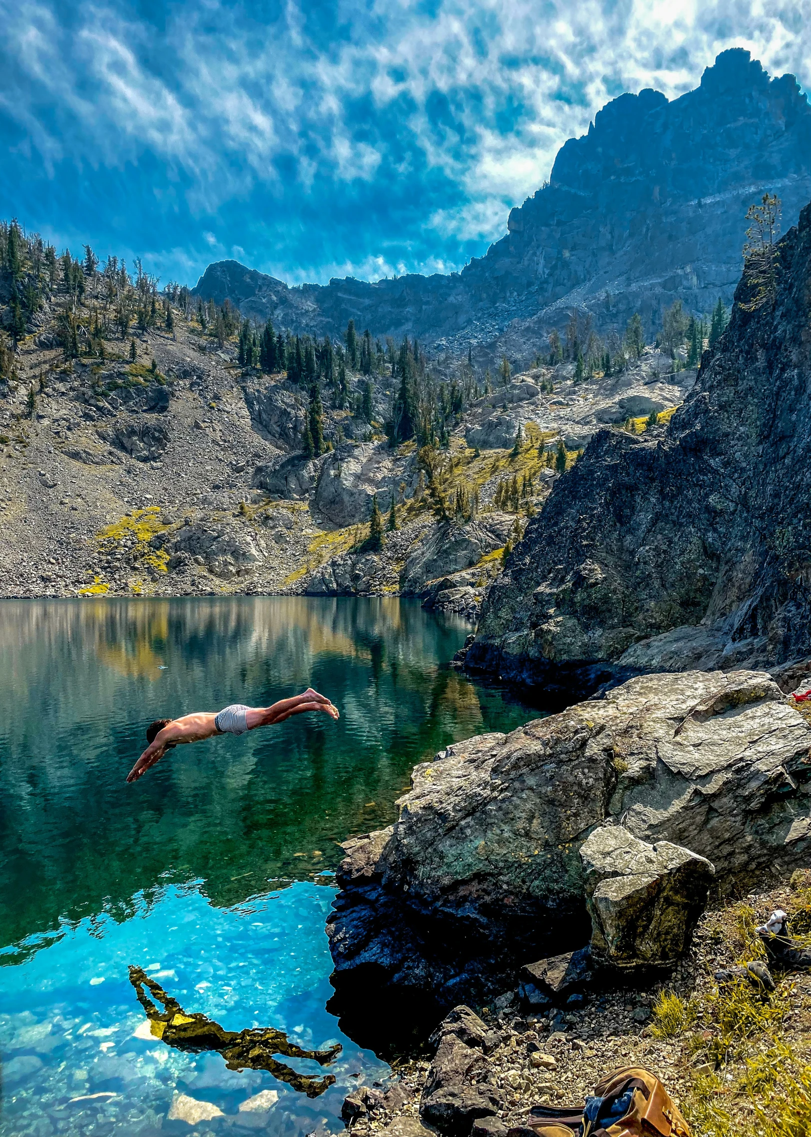 a lake with mountains behind it and water on the side