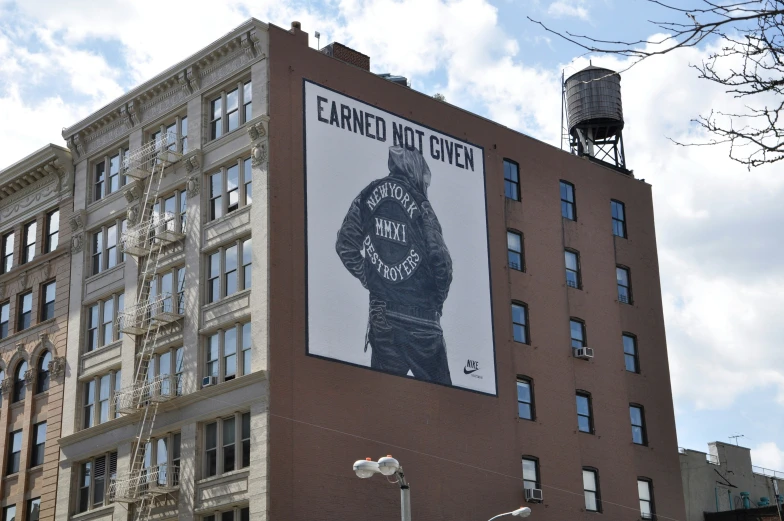 a brick building has a large advertit on it