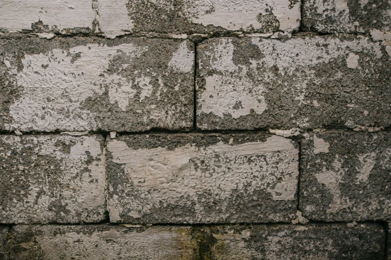 a close up view of a wall made of cement bricks