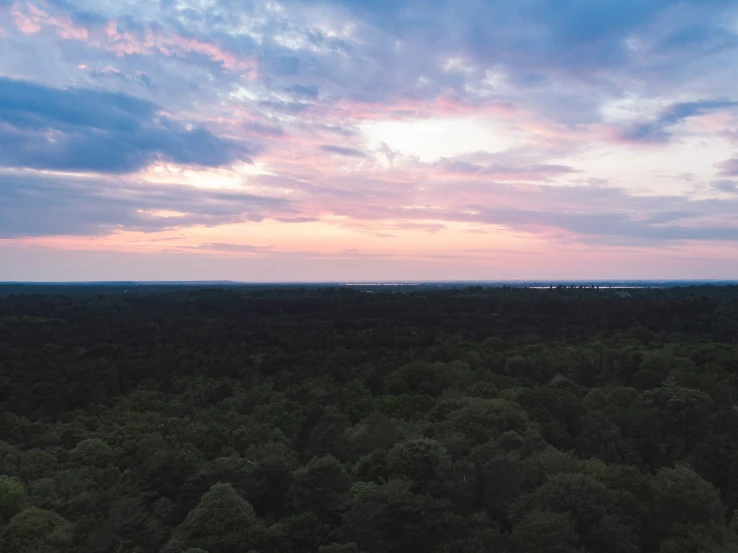 a lone bench in the middle of a beautiful sunset