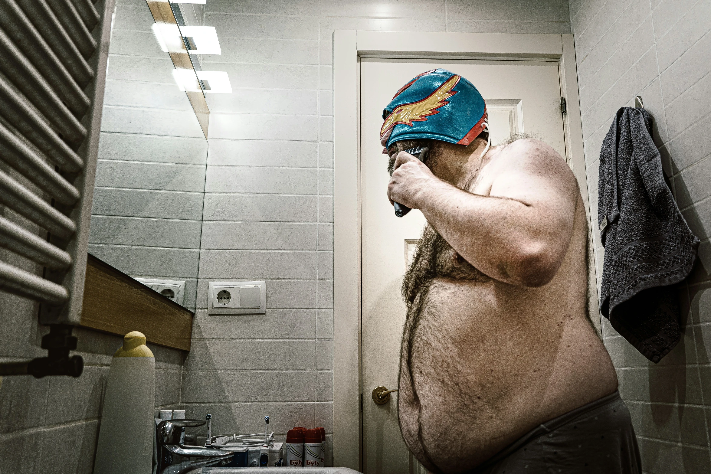 a fat man standing in front of a mirror in a bathroom