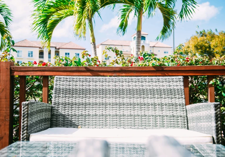 a patio with a bench and some plants