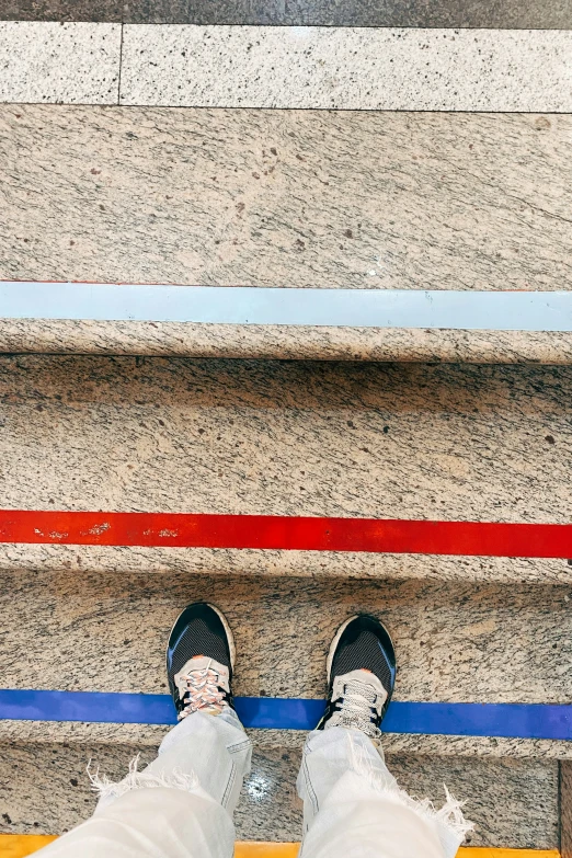 the bottom view of a person standing on stairs