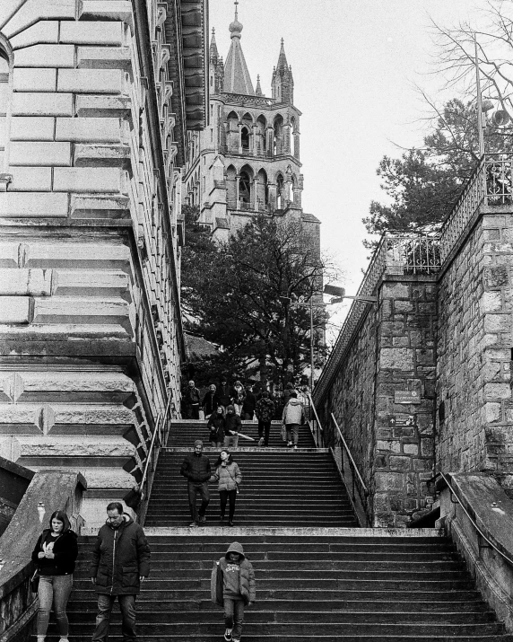 stairs lead down to an old - fashioned building, which contains steeple and spires