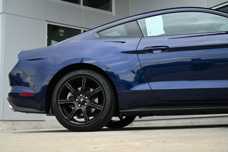 there is a very shiny blue mustang car