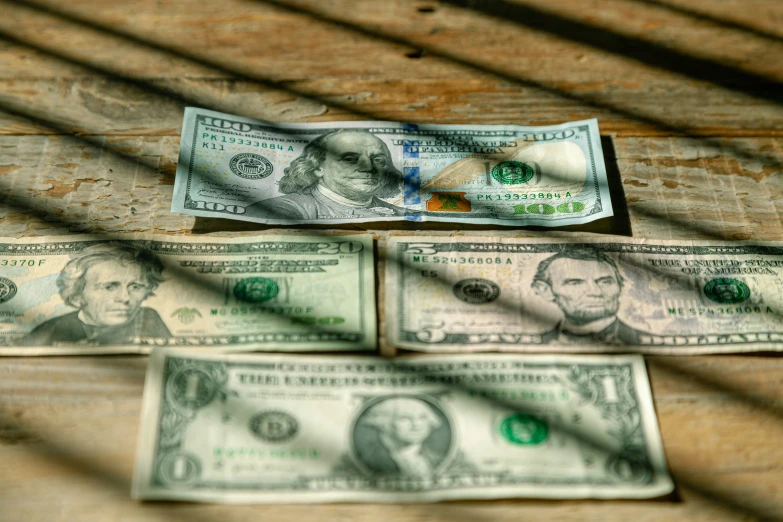 three dollar bills are placed on a table