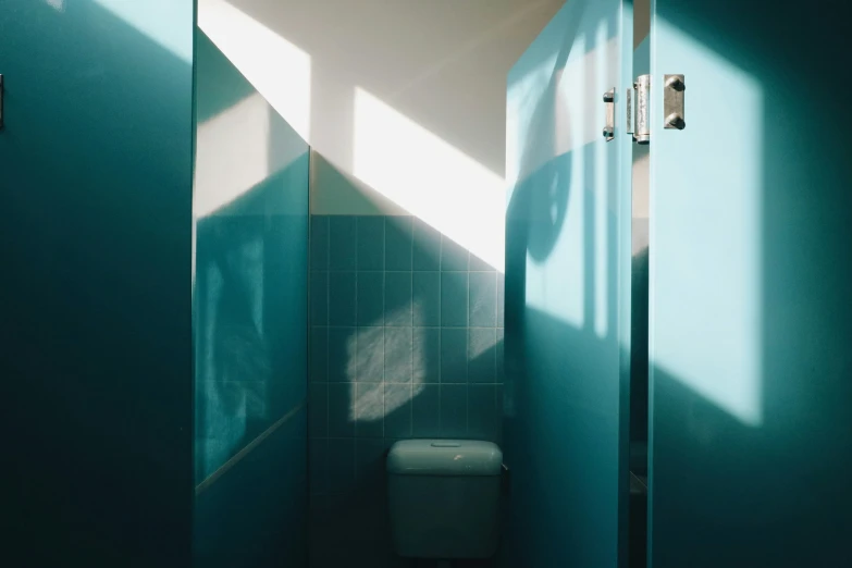 a bathroom with a toilet and blue walls