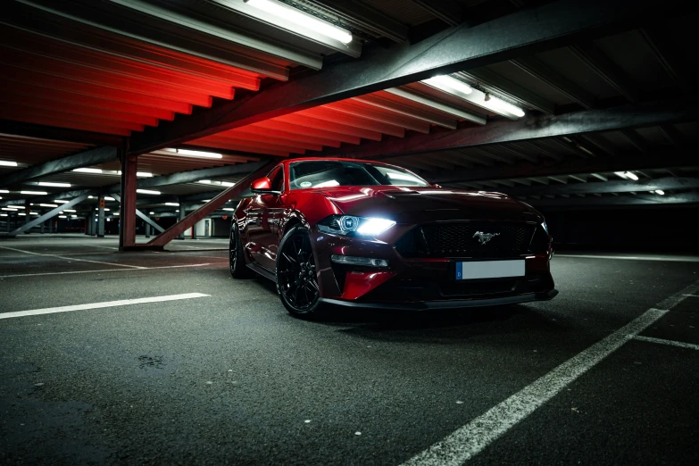 the car is parked under the building underpass