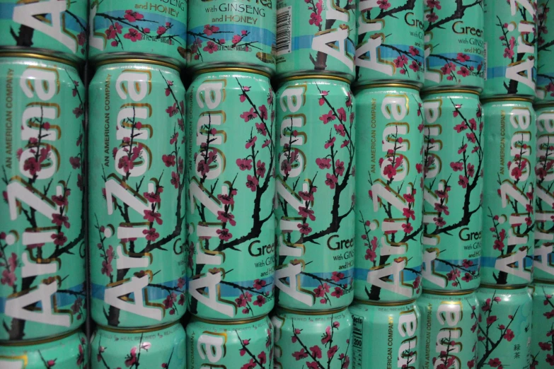 a stack of green cans with cherry blossoms