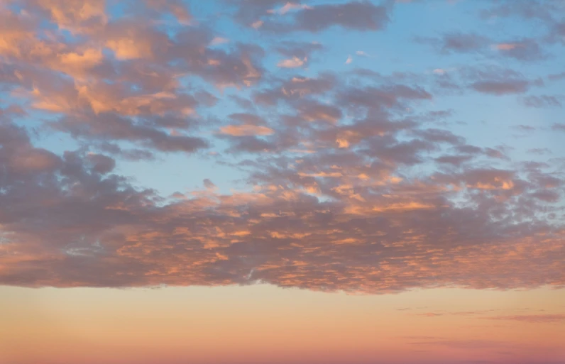 colorful and blue sky with yellow sunlit clouds