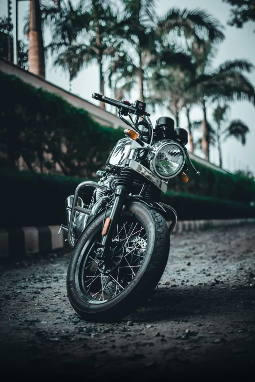 a motorcycle is parked on a dirty road