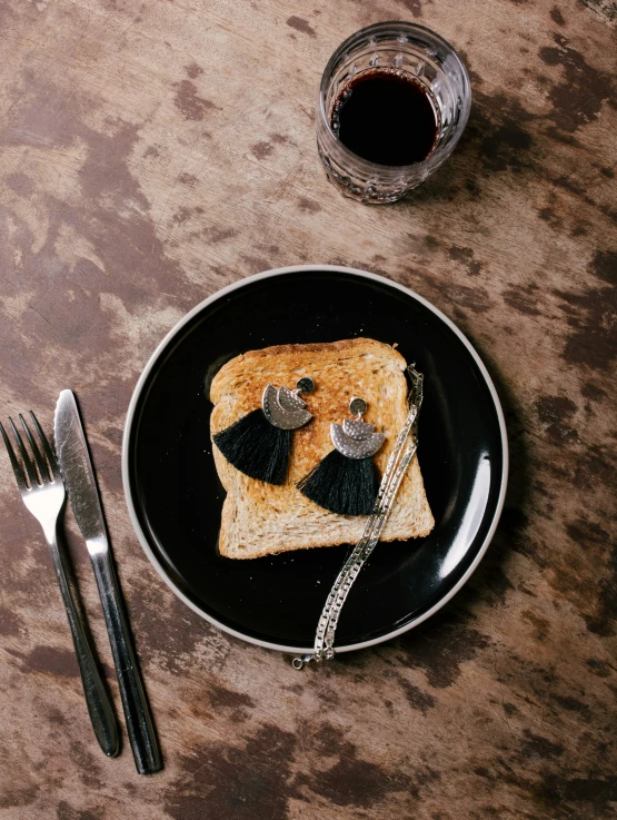 a black plate topped with a toast cut in half