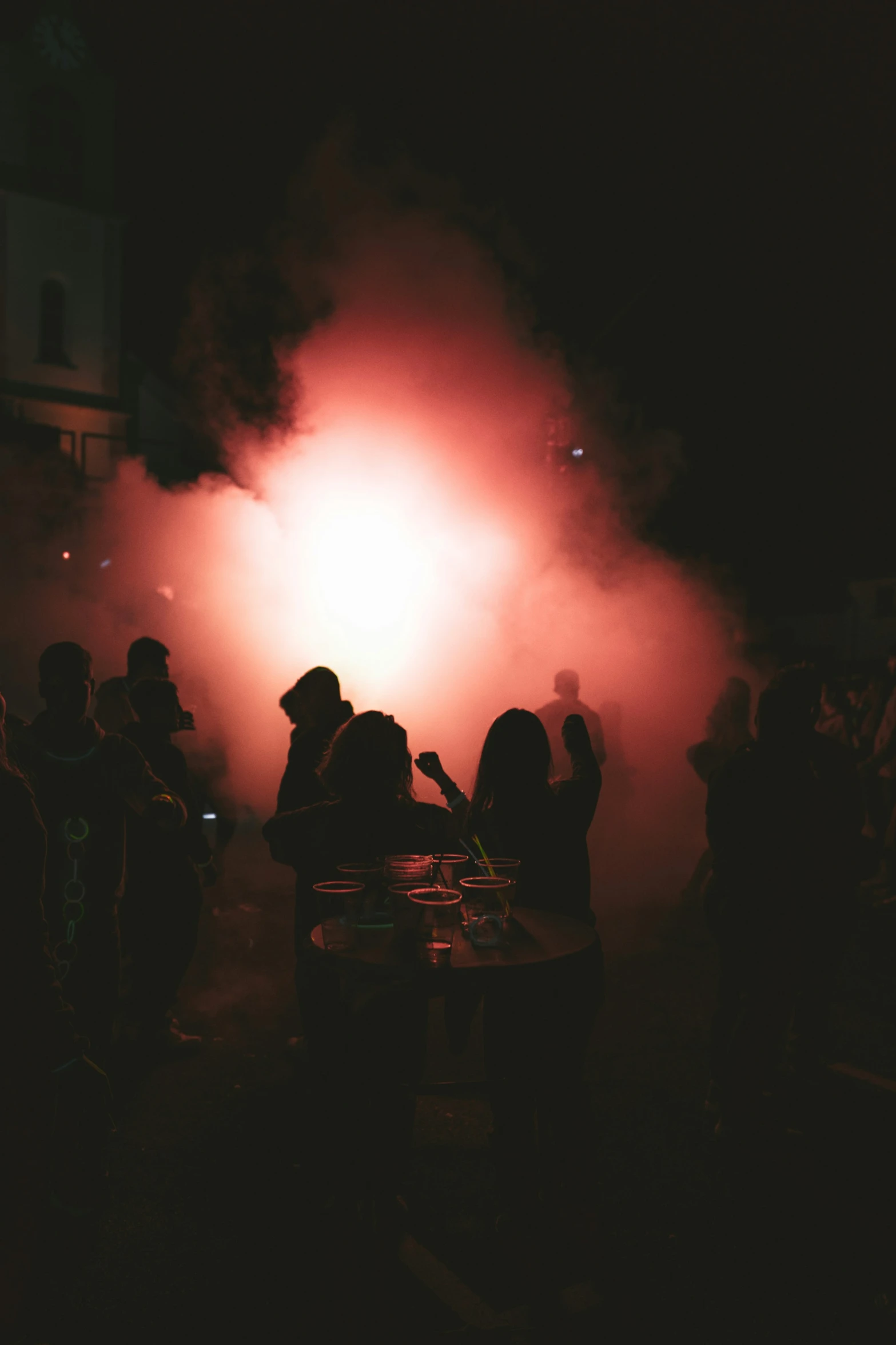 smoke on a dark street in front of some people