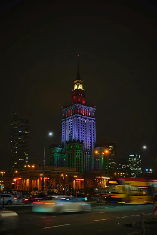 the bright lights are lit up over the city buildings