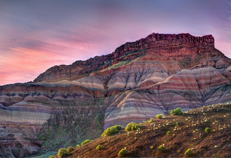 a view of a canyon with pink and orange colors