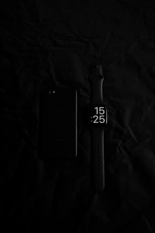 a close up of a cell phone near a watch