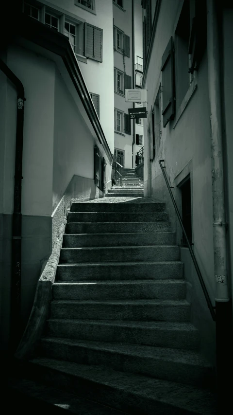 black and white po of stair leading up into an apartment complex