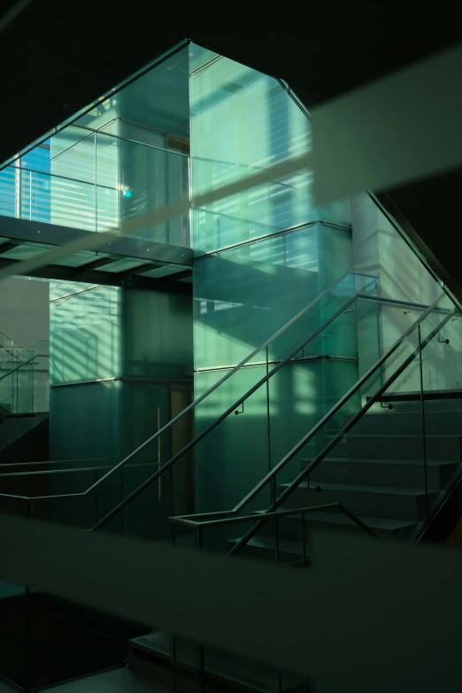 a staircase case is next to a glass wall