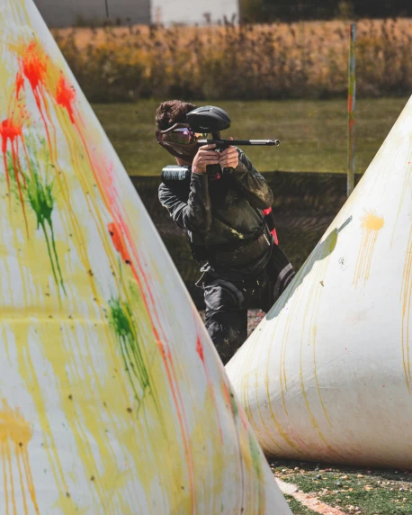 a paint - splattered po of a man shooting