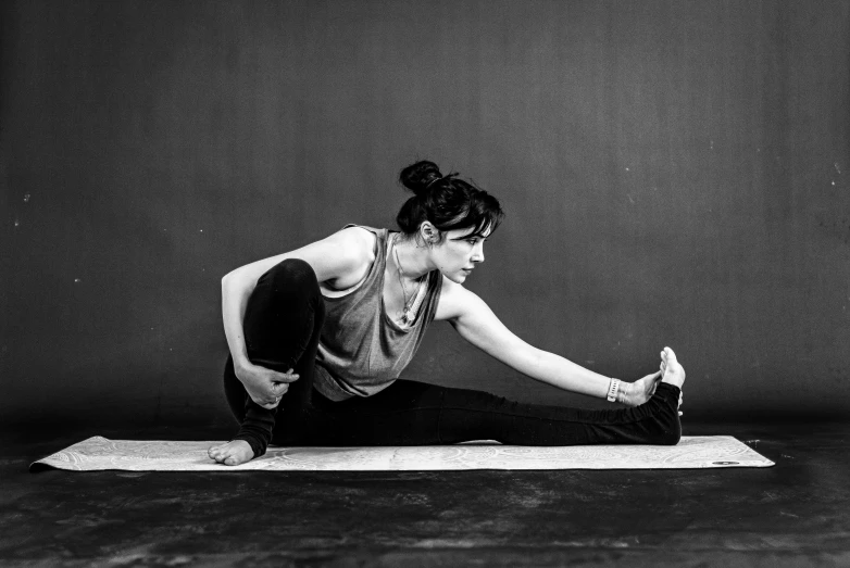 the woman is practicing her yoga pose on a mat