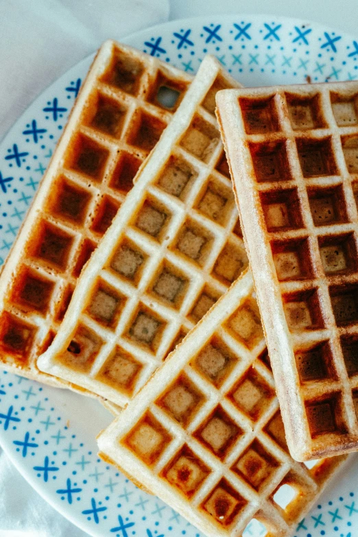 two waffles on a plate are stacked on top of each other