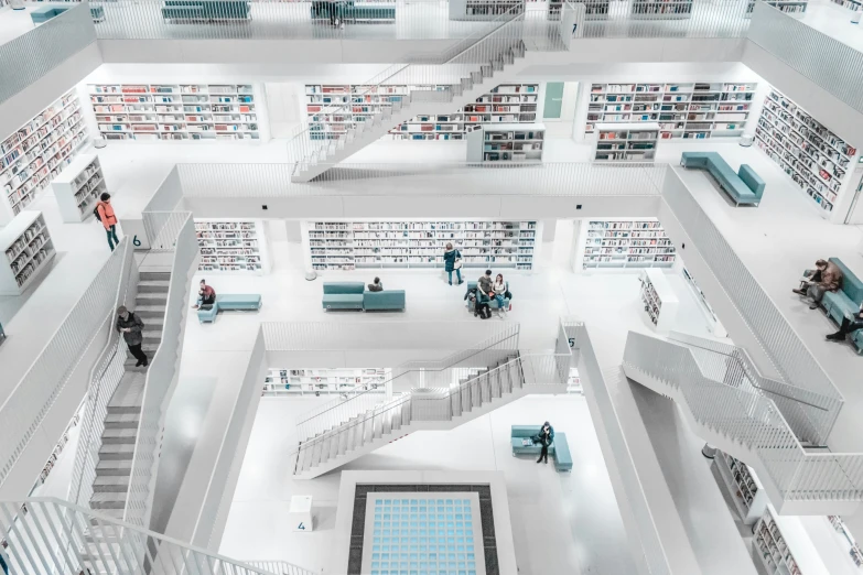 a 3d model of a liry with staircases, bookshelves and several people standing around