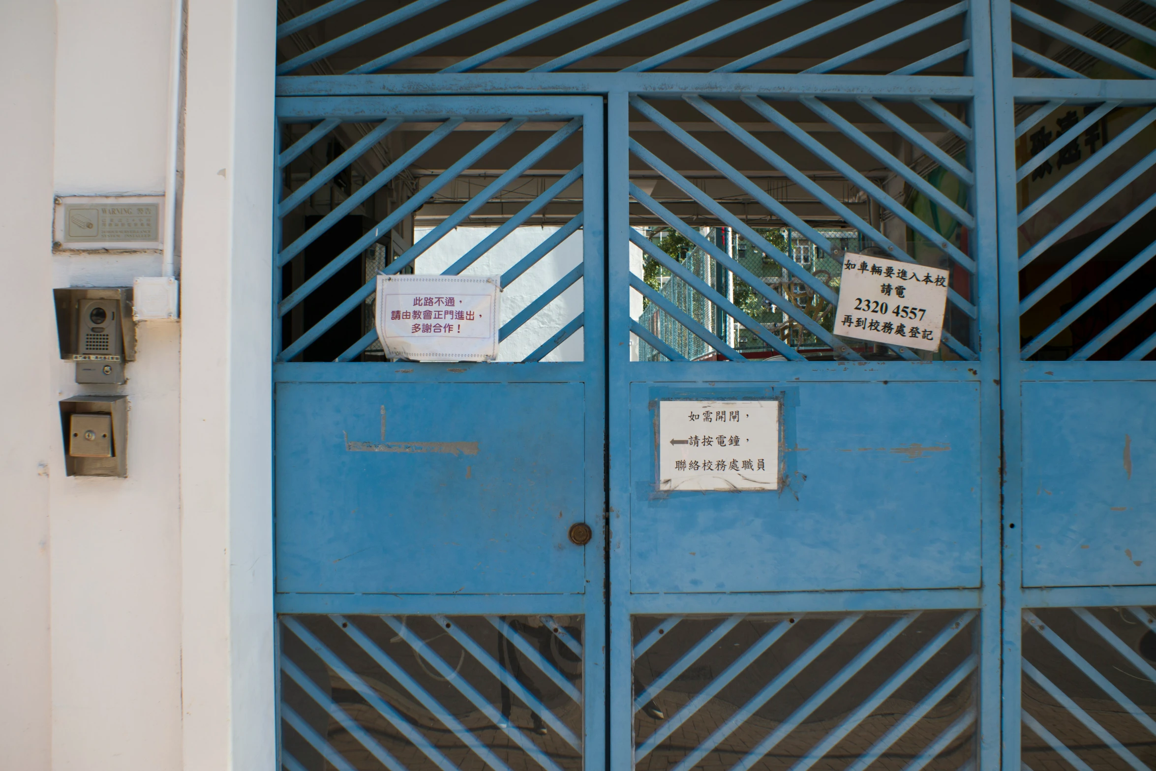 a building with blue doors that has some signs on it