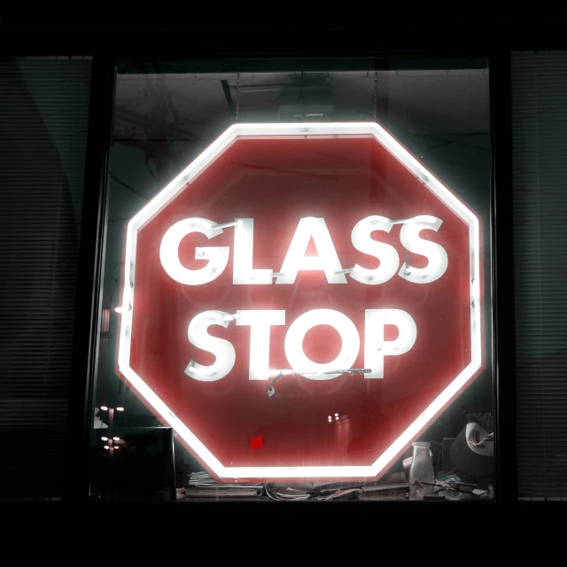 a red stop sign with the words glass stop on it