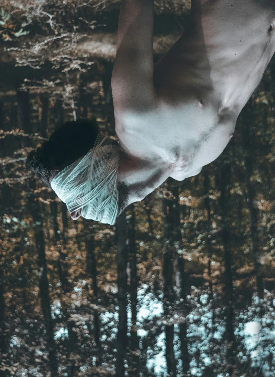 a man is swimming upside down through the water