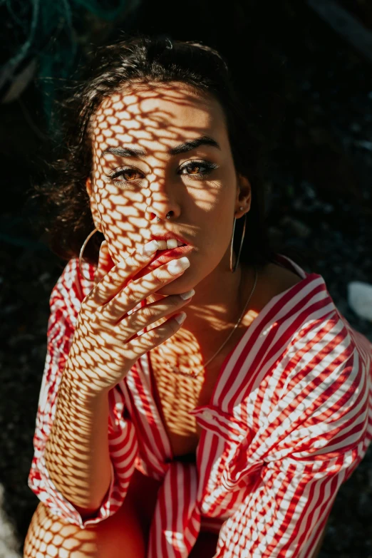 a woman standing on the ground covering her mouth